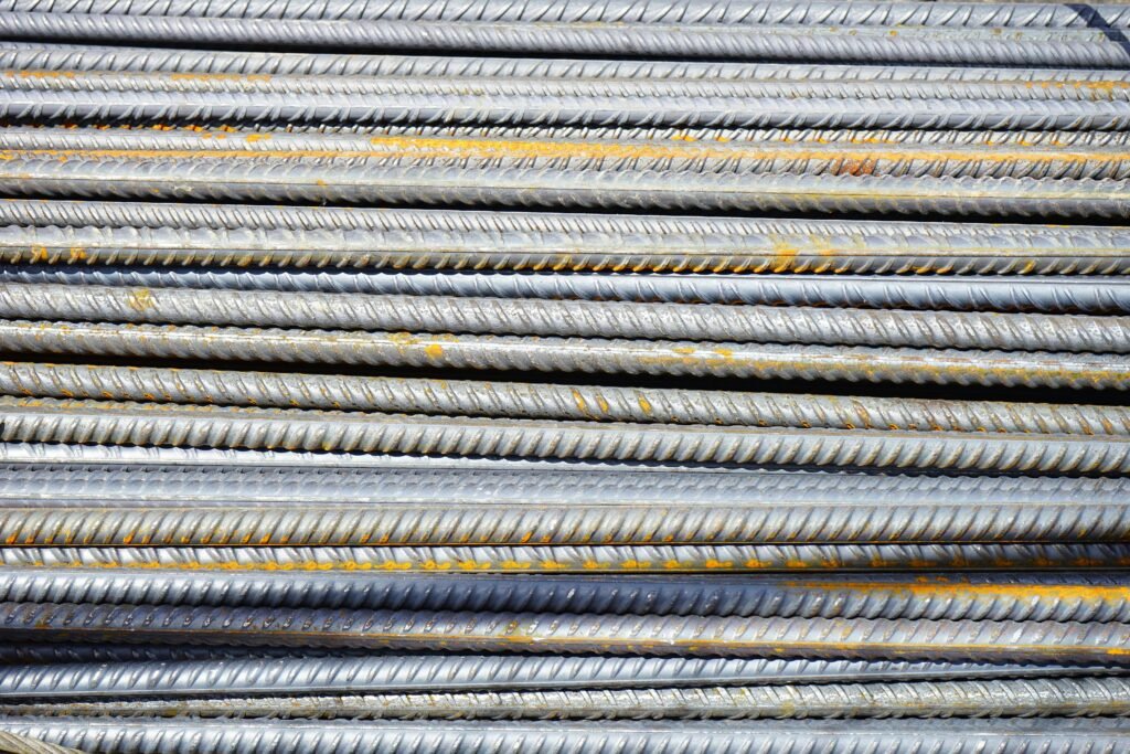 iron-rods-reinforcing-bars-rods-steel-bars-46167-46167 Close-up of stacked rusty steel reinforcing bars used in construction.