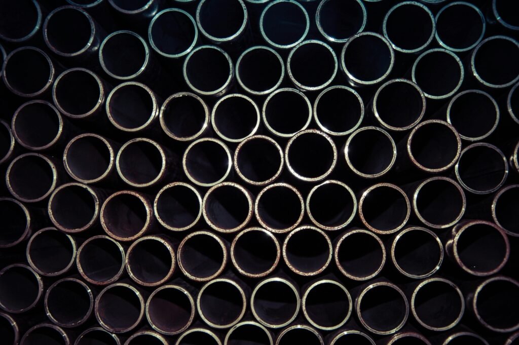 pexels-photo-1381938-1381938 A detailed macro shot of stacked metal tubes forming a circular pattern, highlighting industrial design.